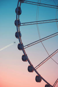 Low angle view of ferris wheel against clear sky