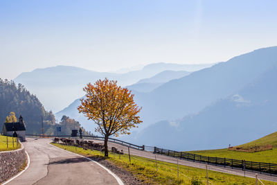 Empty road along countryside landscape