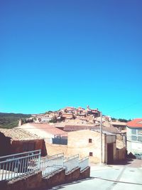 Low angle view of houses against blue sky