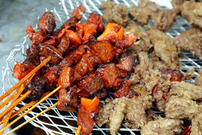 High angle view of meat on barbecue grill