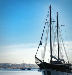 Sailboats in sea against sky