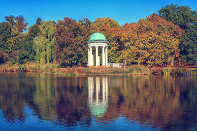 Reflection of trees in lake against sky during autumn