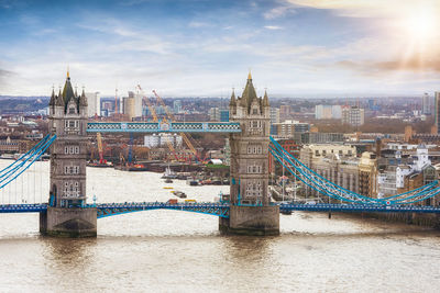 Tower bridge over river with city in background