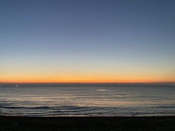 Scenic view of sea against clear sky during sunset