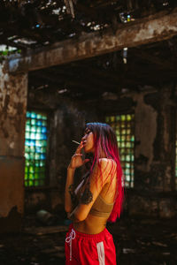 Young woman standing at home