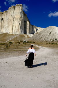 Full length rear view of man on rock