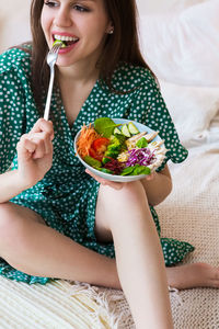 Midsection of woman eating food