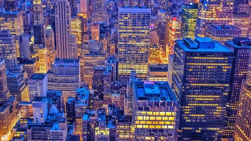 High angle view of city lit up at night