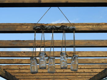 Low angle view of clothes hanging on rope against sky