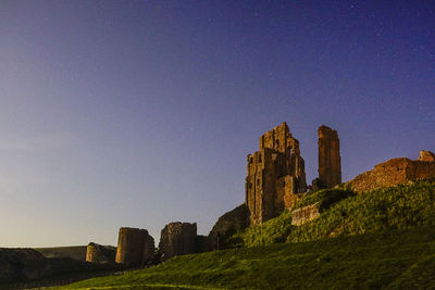Low angle view of castle against clear blue sky