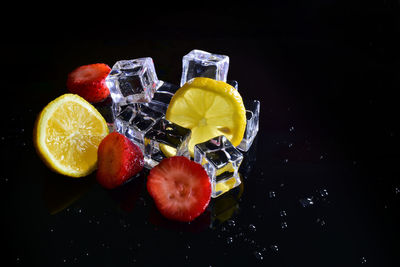 Close-up of fruits against black background