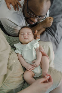 Smiling father and mother with baby girl at home