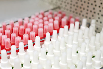 White and red plastic bottles with glue. abstract background. bottles with glue on shelf in store