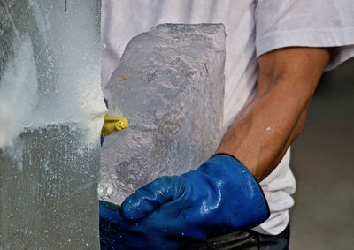 Midsection of man holding ice