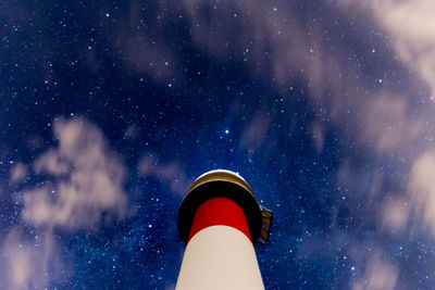 Low angle view of far del fangar lighthouse and stars against sky at night