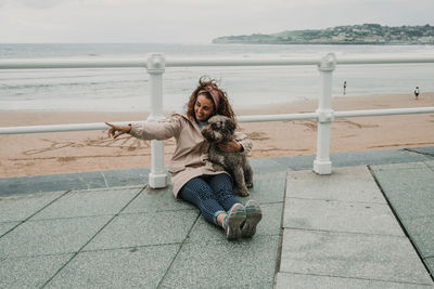 Happy woman with dog at beach