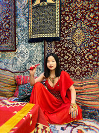 Portrait of young woman sitting on sofa