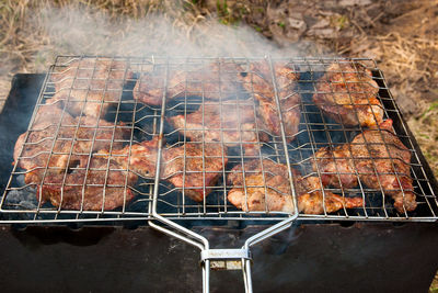 High angle view of meat on barbecue grill