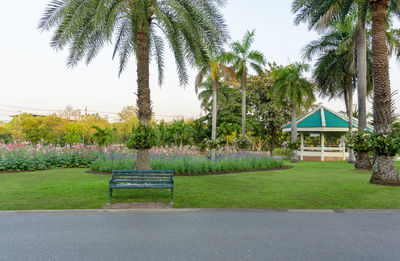 Park bench by building against sky
