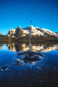 Close-up of water splashing against blue sky