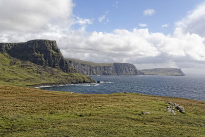 Scenic view of sea and mountains against sky