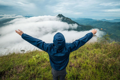 Full length of man standing on mountain against sky