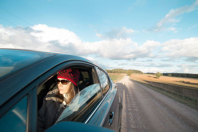 Woman traveling in car on road