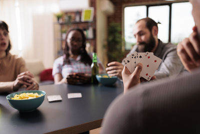 Friends playing cards at home