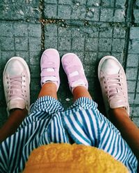 Low section of women standing on footpath
