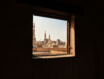 Buildings and mosques seen through window