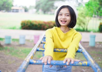 Portrait of a smiling girl standing outdoors