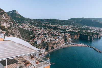 High angle view of townscape by sea against sky