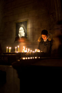 Man and woman standing against illuminated building in temple