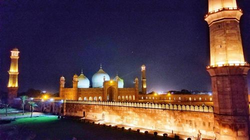 Illuminated building against sky at night