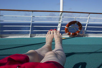 Low section of woman relaxing on deck