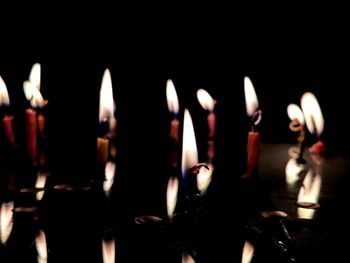 Close-up of burning candles in temple