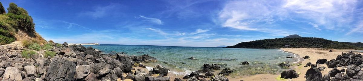 Panoramic view of sea against blue sky