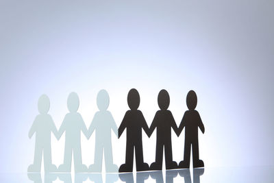 Low angle view of silhouette man against white background