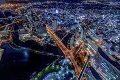 Aerial view of illuminated buildings in city at night