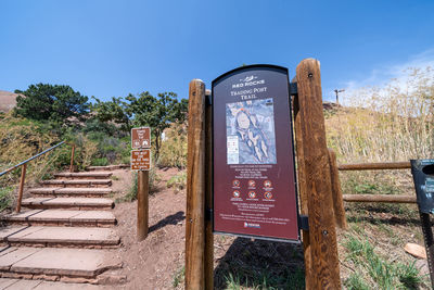 Text on railing against clear blue sky