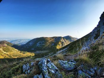 Scenic view of mountains against blue sky