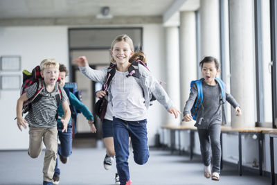 Excited pupils rushing down school corridor