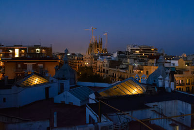 High angle view of illuminated buildings against sky at night