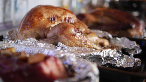 Close-up of roasted chicken meat in foil