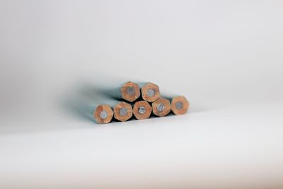 Close-up of coins on table against white background
