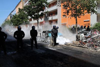 People working on street against buildings in city