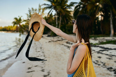 Rear view of woman holding umbrella