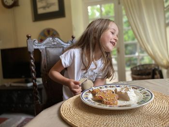 Woman sitting on table at home