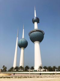 Low angle view of communications tower against sky in city