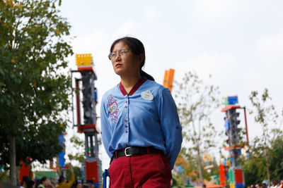 Low angle view of young woman looking away